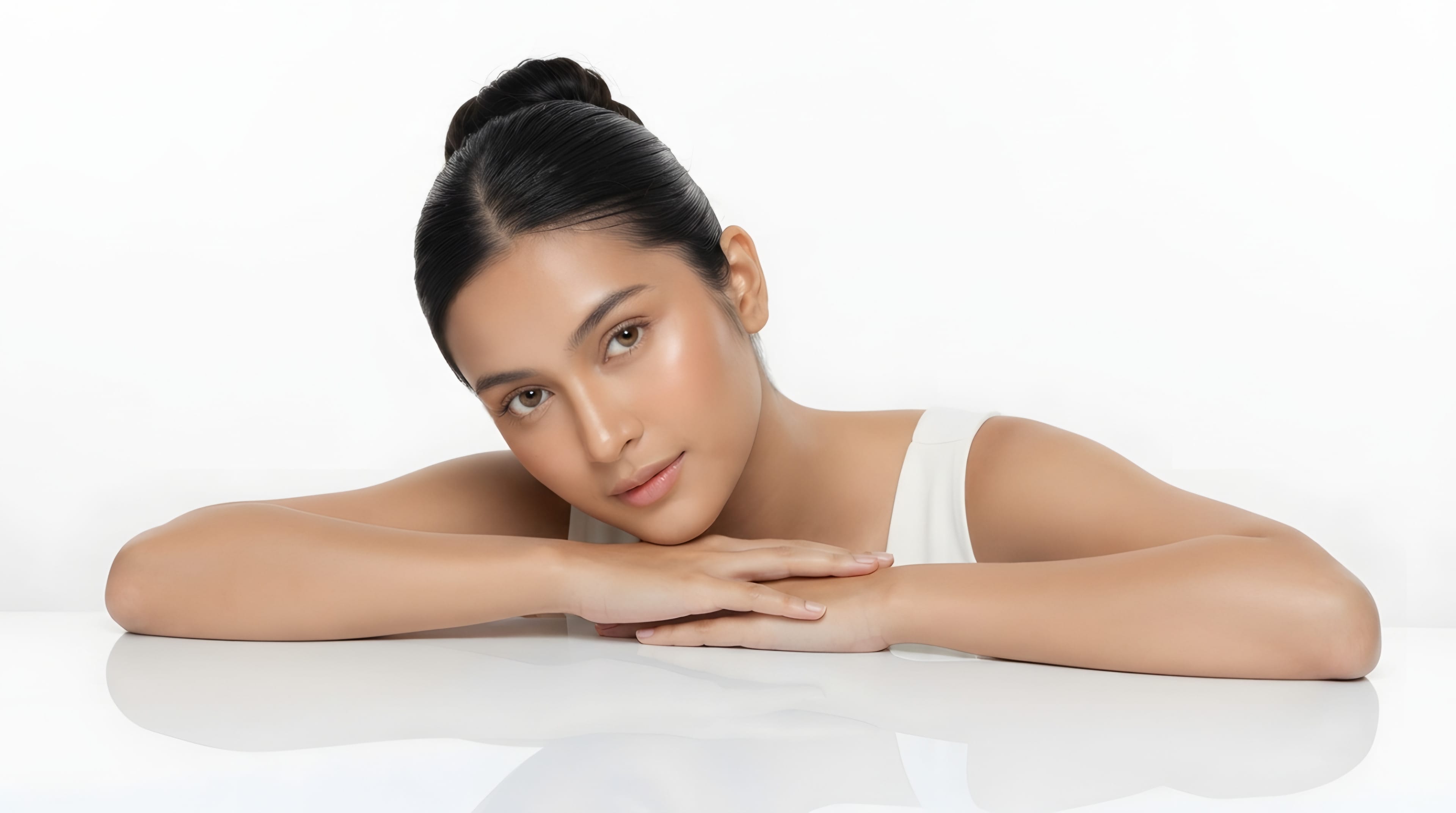 Woman resting her head on her hands, smiling softly